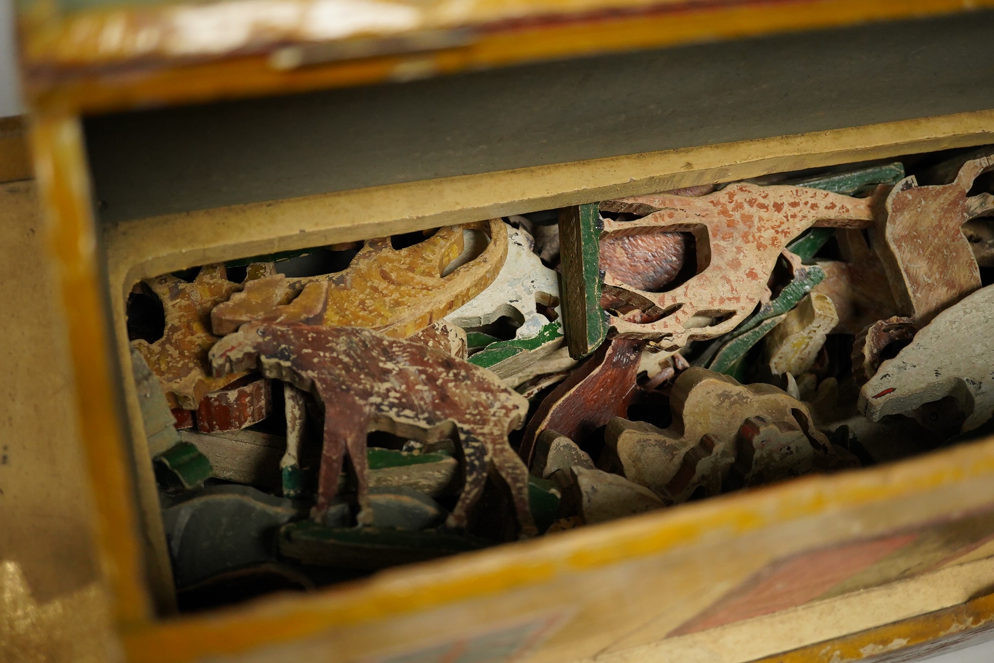 An early 20th century painted pine Noah's Ark and semi-flat animal figures, the hull 68.5cm long. Condition fair, general wear and scuffing to the paintwork.